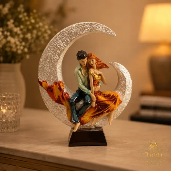 Romantic couple sitting on a crescent moon decorative showpiece for home décor and gifting.